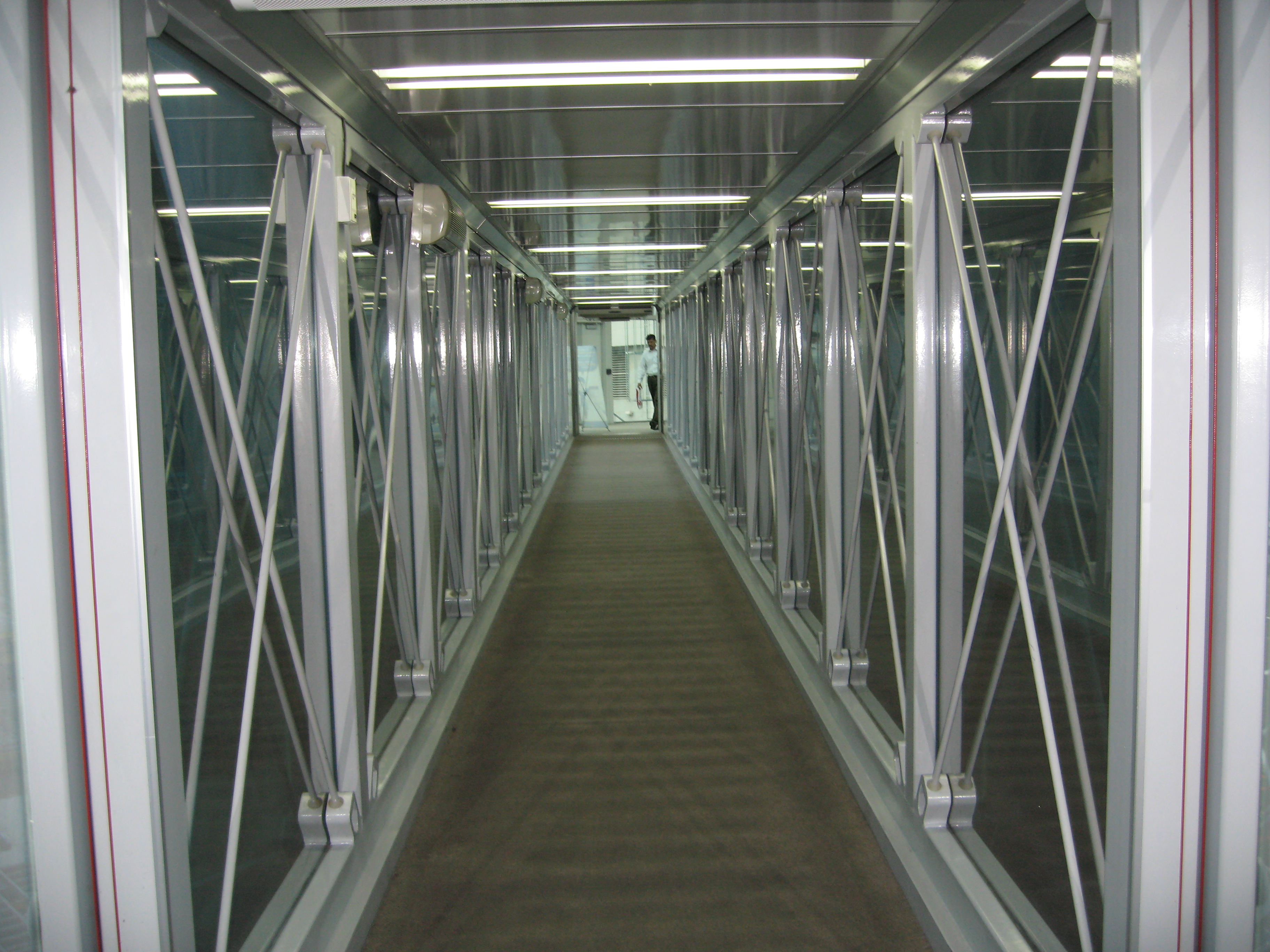 Empty jet bridge representing seamless transitions
